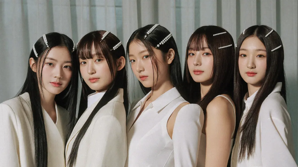 Five young women in white with pearl hair clips